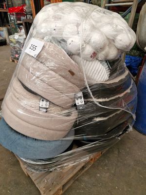 a pile of mattresses sitting on a pallet in a warehouse