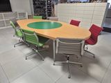 a large conference table with four chairs around it