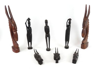 several wooden figurines of different shapes and sizes on a white surface