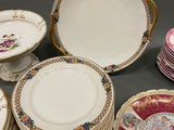 many plates and cups that are sitting on a table