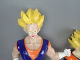two figurines of dragon ball characters on a table