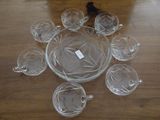 a lot of glass cups and saucers sitting on a table
