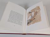 an open book with a drawing of a man riding a horse