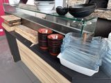 a glass shelf with bowls and plates on it