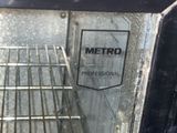 a black oven with a door open and a sign on it