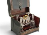 a wooden box with a bunch of glasses inside of it