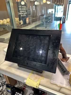 a black picture frame on top of a counter in a store