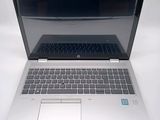 a laptop computer that is open on a white surface
