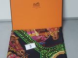 a black and orange scarf with an orange box on top of it