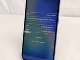 the back of a phone with a display on it sitting on a white surface