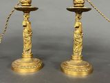 pair of antique brass candlesticks with figurines and chains