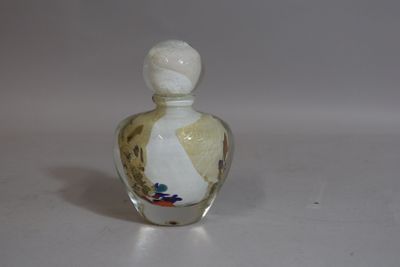 a small glass bottle with a design on it
