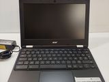 a laptop that is sitting on a table with a charger