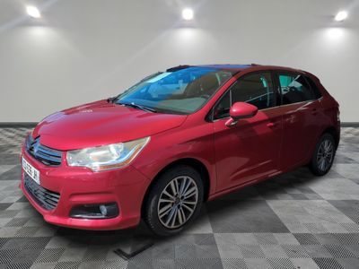 a red car is parked in a room with a checkered floor