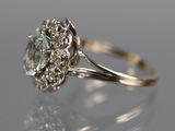 a close up of a diamond ring on a reflective surface