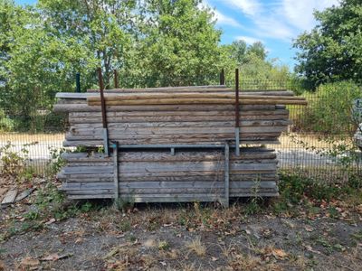 a pile of wood sitting in the middle of a field