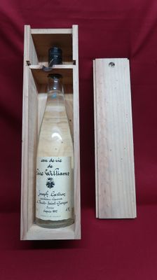 an empty bottle of wine in a wooden box on a red background