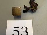 a close up of a small metal object on a table next to a paper