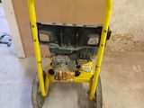 a small yellow hand truck with a black handle