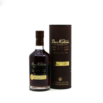 une bouteille de whisky posée à côté d'un carton sur une surface blanche