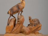 sculpture of a deer and two baby deer on a wooden base