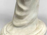 an antique statue of a woman with a veil on her head