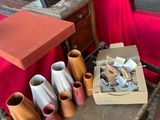 many vases sitting on a table with a red table cloth