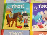several children ' s books are lined up on a table