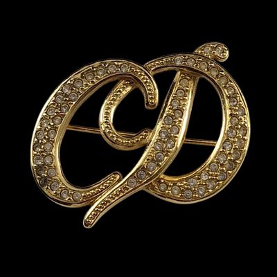 an image of a gold broochle with diamonds on it