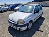 a small white car parked in a parking lot