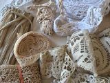 many different types of crochet and laces on a table