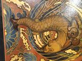 a picture of a picture of a dragon on a wall