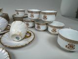 a lot of cups and saucers on the table
