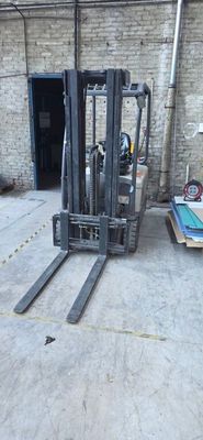a forklift sitting in the middle of a warehouse