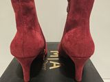 a close up of a pair of red high heeled shoes on a box