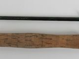 a close up of a fishing rod on a white surface
