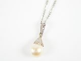 un pendentif en perles blanches et diamants sur une chaîne en argent