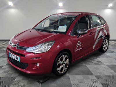 the red citrole is parked on a checkered floor