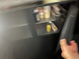 une photo floue de la main d'une personne tendue vers de la nourriture dans un réfrigérateur