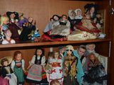many dolls on the shelves in the room