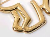 a gold brooch with the letter y on it