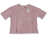 a pink t - shirt with white flowers on the chest