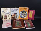 several books are lined up on a black surface