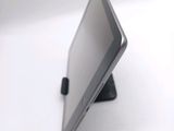 a tablet computer sitting on a stand on a white surface