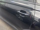 a black car parked on the side of the road