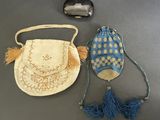 two purses and a hat sitting on a table