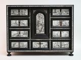a black and white chest of drawers with pictures on it