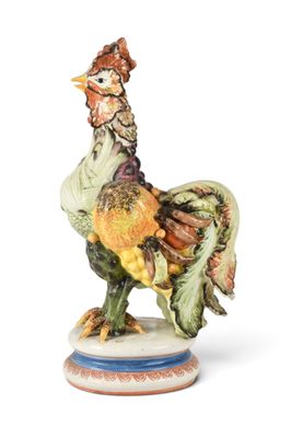a figurine of a rooster standing on a plate