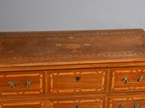 a wooden dresser with many drawers and drawers on it