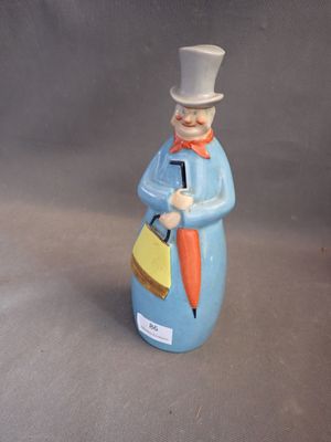 a figurine of a man with a top hat and tie